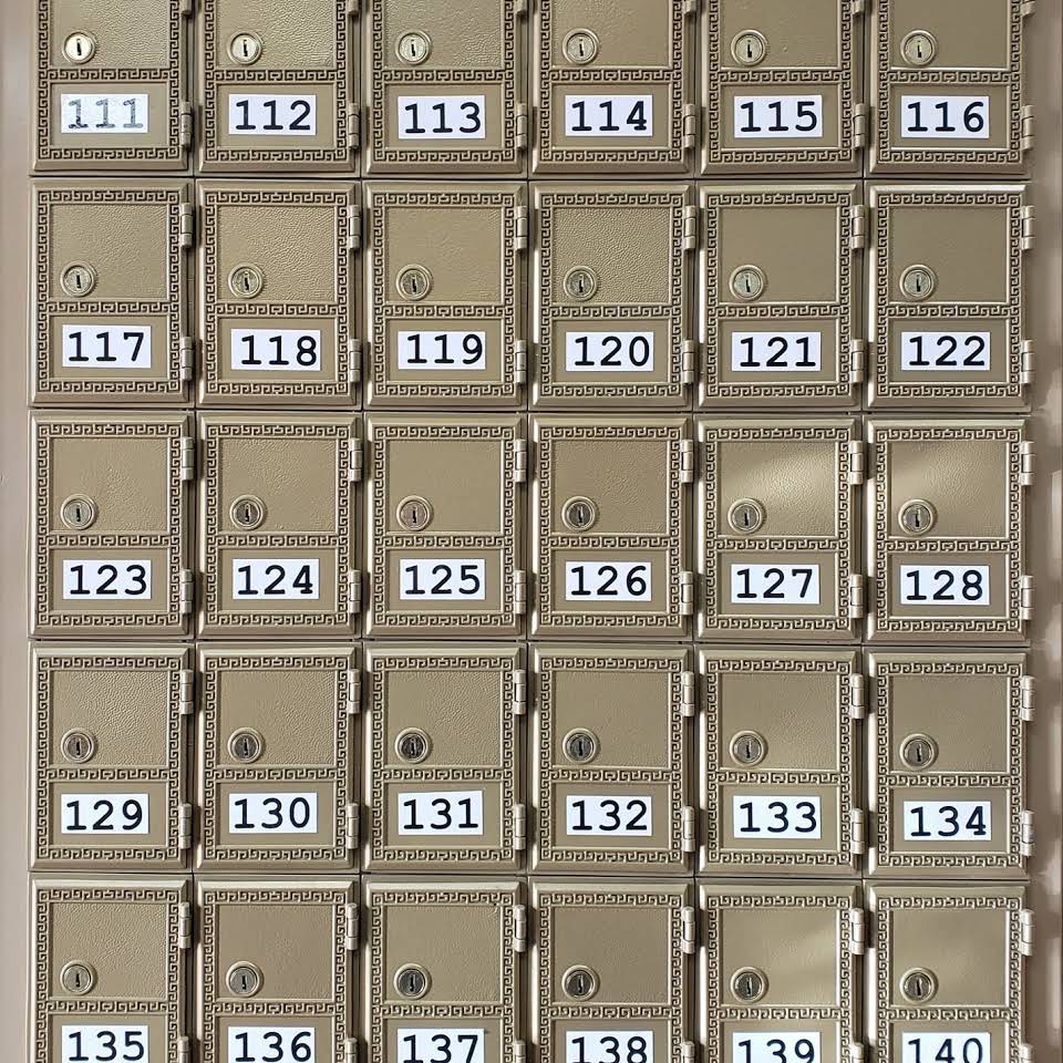 A wall mounted mailbox with numbers on it
